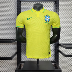 Brazil Yellow soccer jersey with Nike logo on a mannequin against a wire mesh background