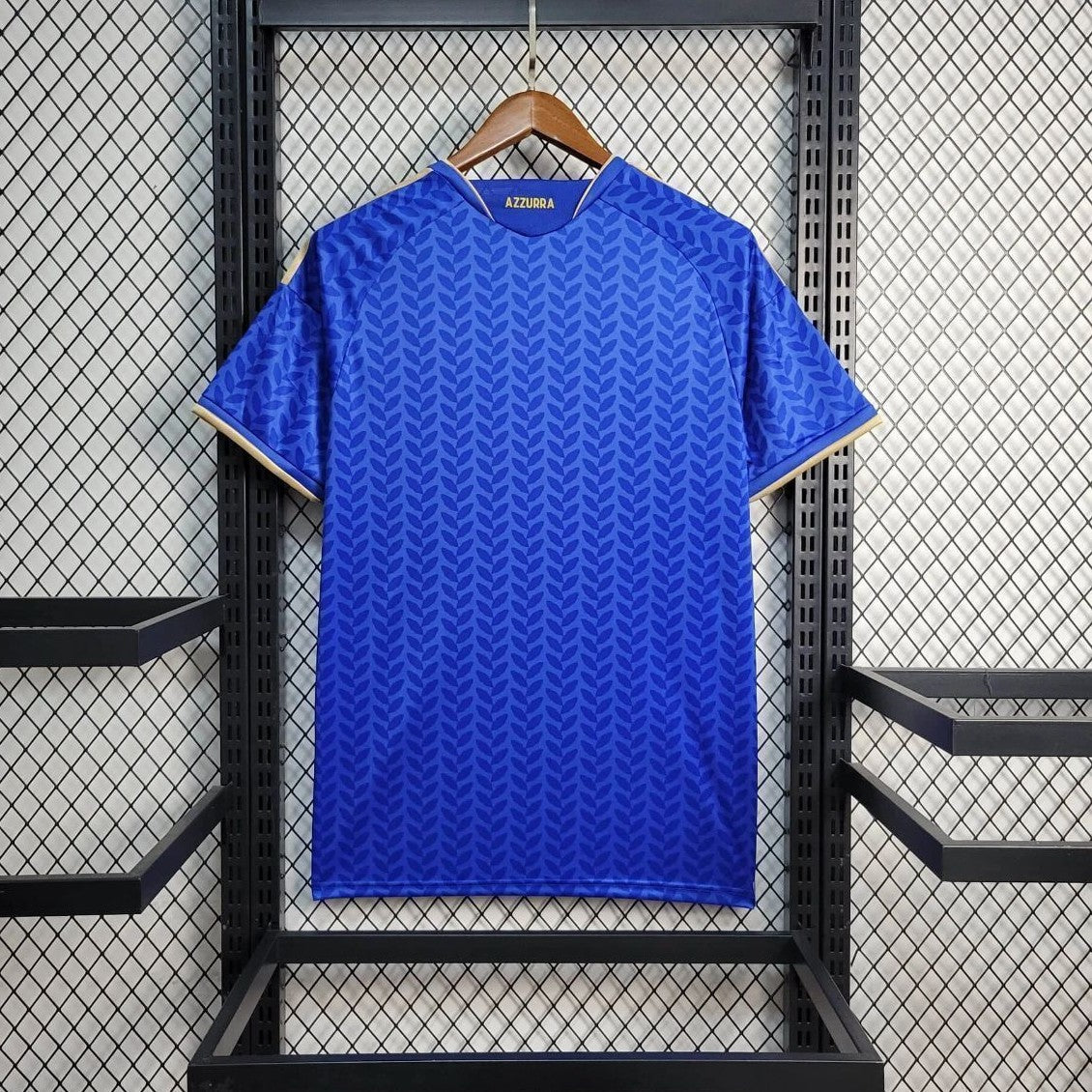 Real side of Italy home jersey wc 2026  anging on a rack with a branded label.